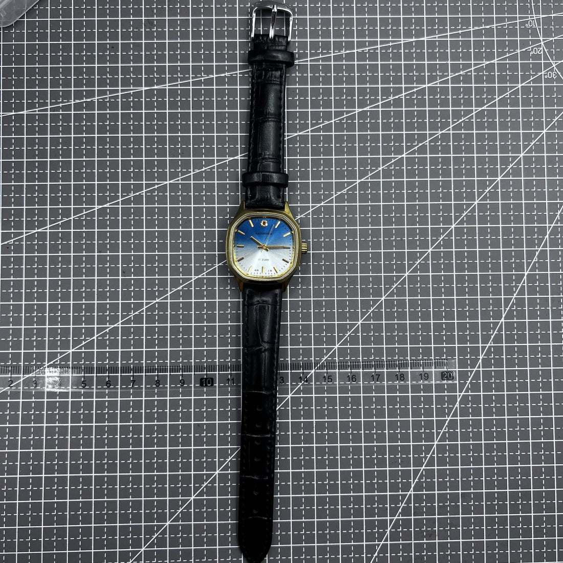 Shanghai 33mm manual mechanical watch with golden nail markers, blue dial, square case, and 17 jewels by Shanghai brand.