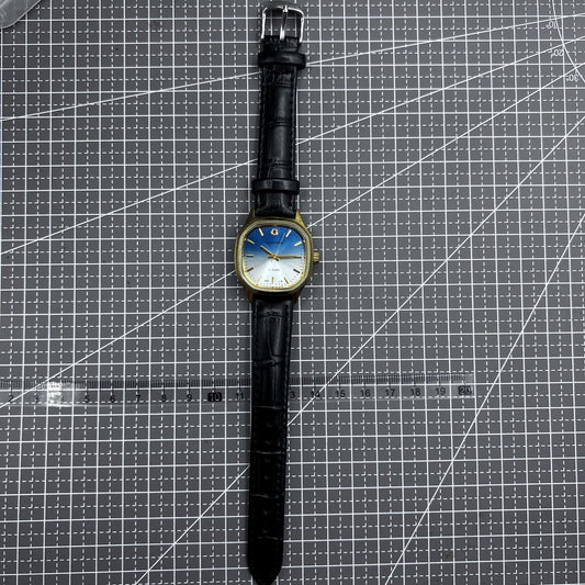 Shanghai 33mm manual mechanical watch with golden nail markers, blue dial, square case, and 17 jewels by Shanghai brand.