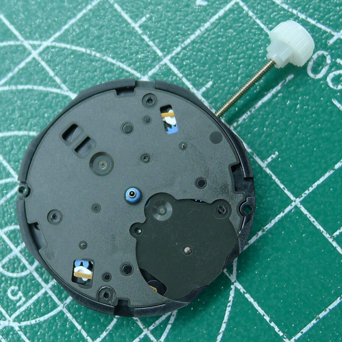 Sunon PE80 quartz watch movement with three hands and small second indicators at 3, 6, and 9 o'clock positions.