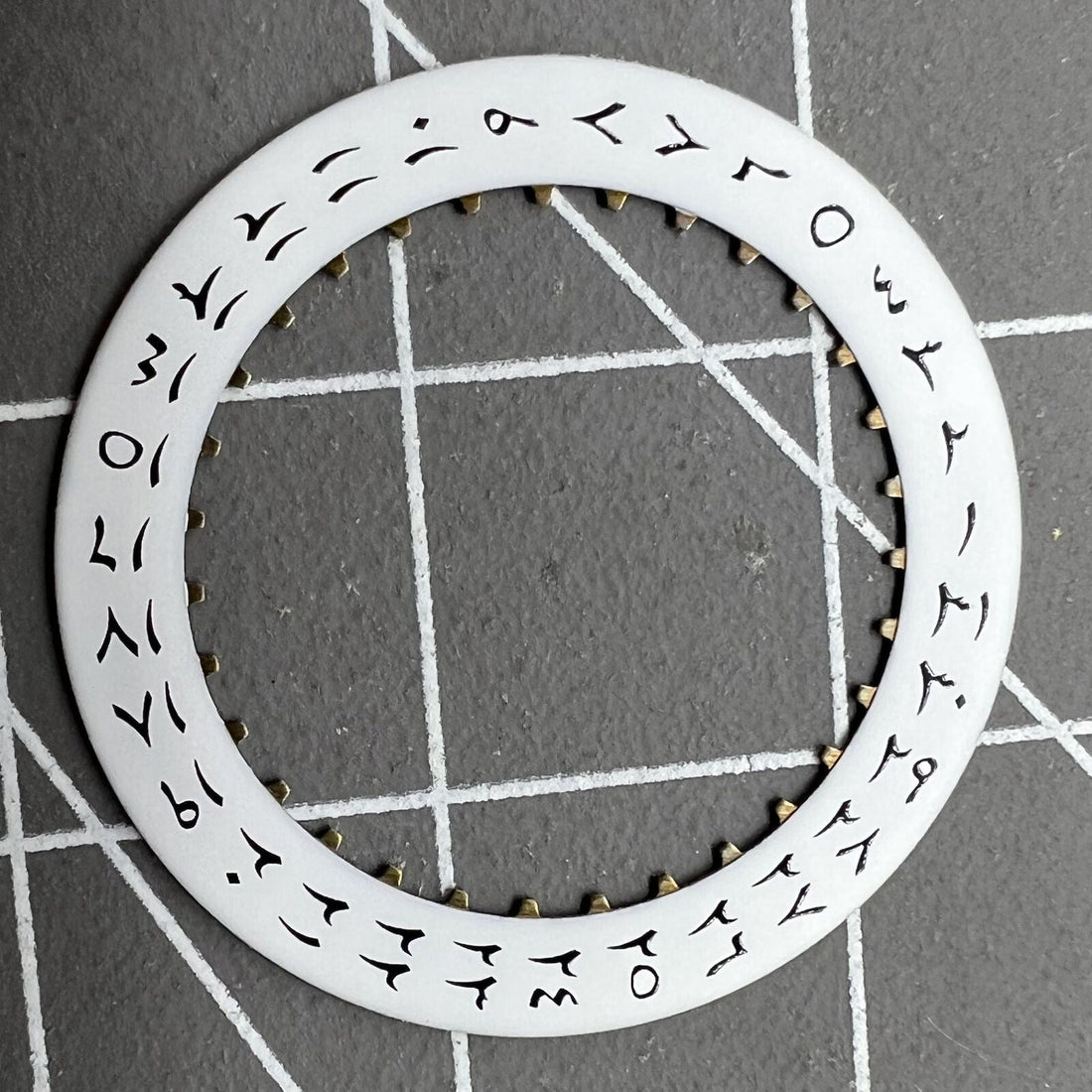 White background close-up of Arabic date disk wheel for ETA2824 Datejust watches, precision component.