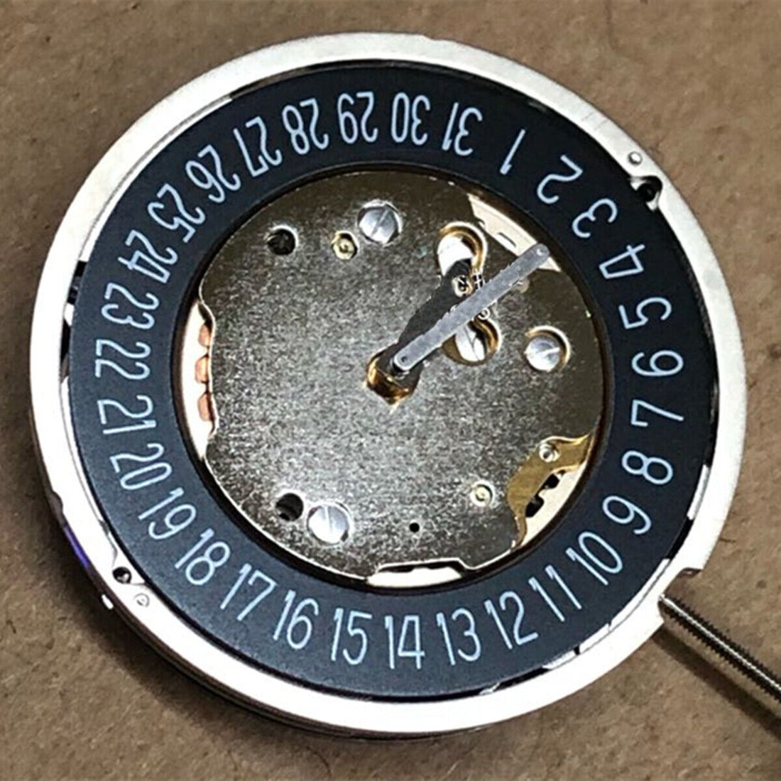 Ronda 5021D quartz watch movement with black finish, Swiss made, date display at 6 o'clock.