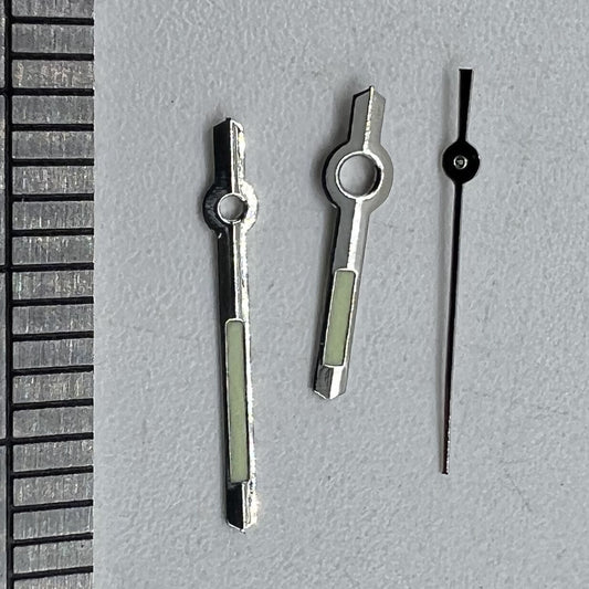 Silver luminous watch hands for Miyota 2035 quartz movement, enhancing visibility and style.