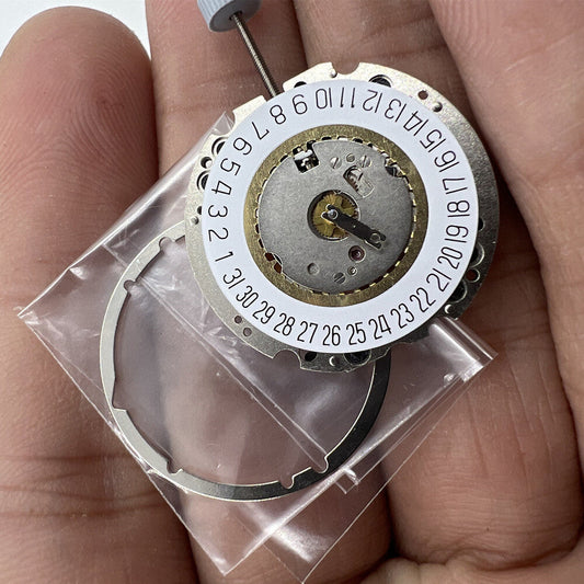 Close-up of Ronda 704 quartz watch movement with date display at 6 o'clock, Swiss precision part.