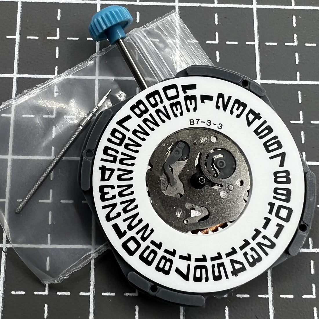 Miyota 6M53 quartz movement displaying big date at 3 o'clock with three hands for precise timekeeping.