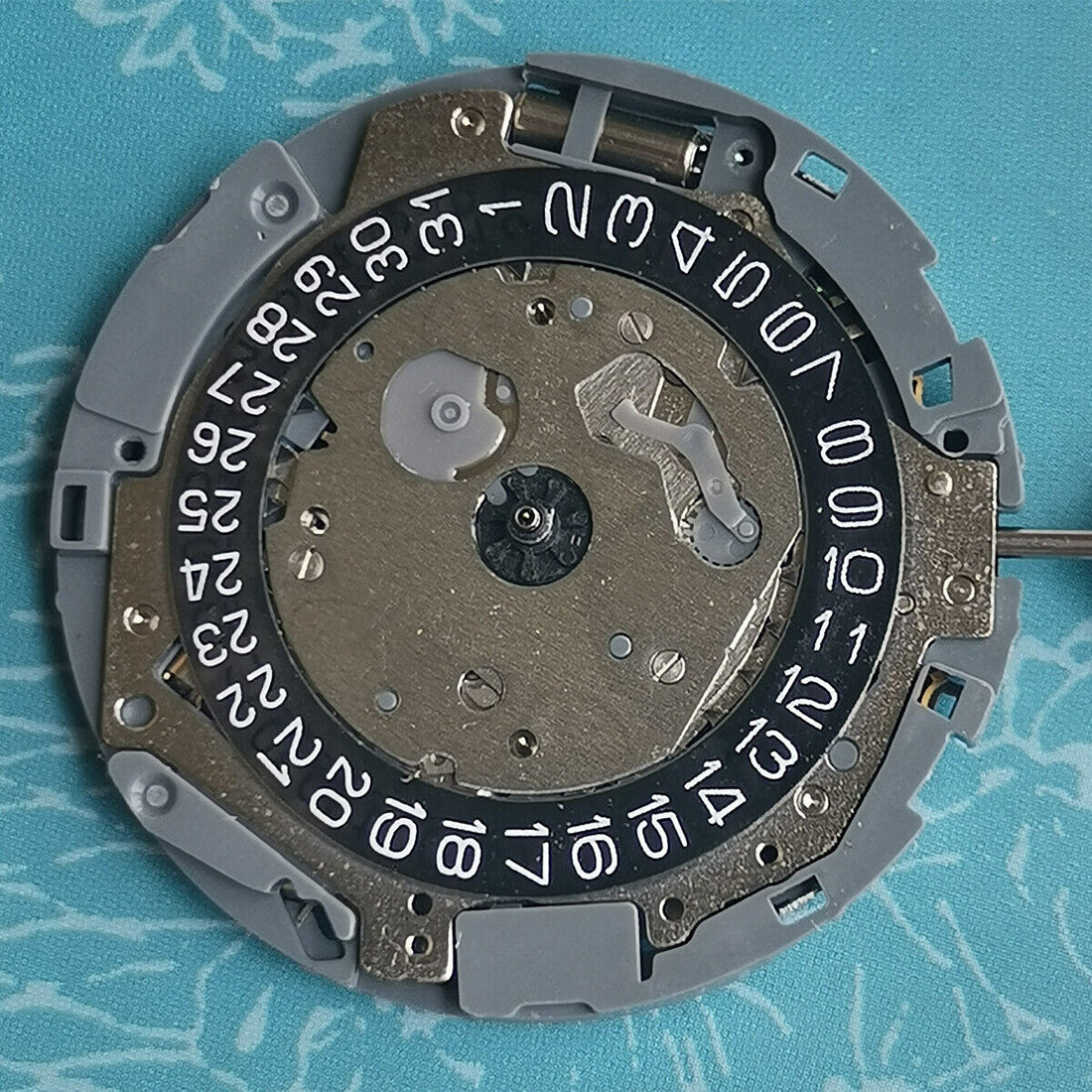 Japan Made Miyota OS11 quartz movement with black disk wheel and date at 4 o'clock, watch part.