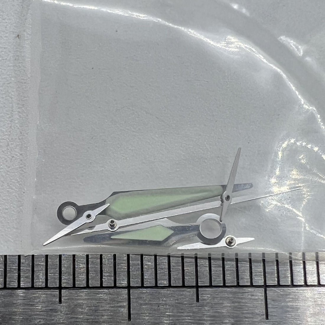 Silver trim luminous watch hands by ETA for G10.211 quartz movement, enhancing readability and style.