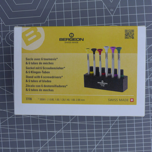 Swiss Bergeon 7778 screwdriver set with 6 precision tips, spare blades, and sturdy stand for watch repair.