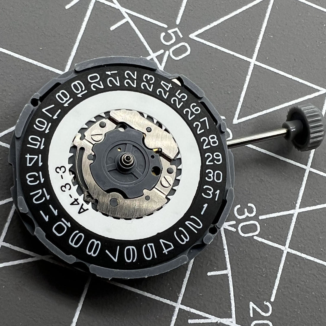 Miyota 6L76 black quartz watch movement disc, Japan-made, for precise timekeeping and repair.
