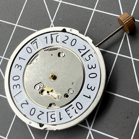 Ronda 6004B quartz watch movement with date display at 12 o'clock, precise timekeeping.
