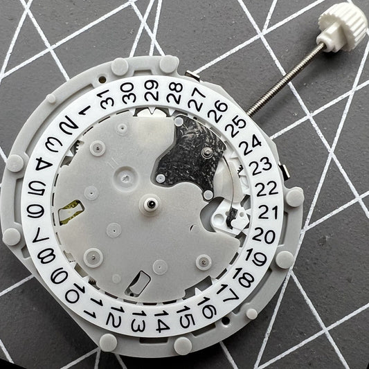Sunon PE70 watch movement with date at 3 o'clock, three hands, and three subdials at 6, 9, and 12 positions