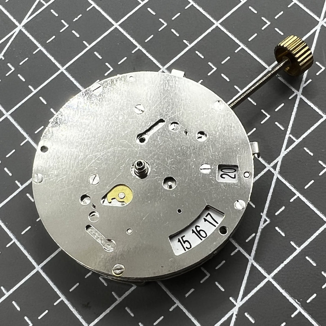 China 8205 automatic watch movement showcasing small second hand at 3 and 9 o'clock, precise mechanics.