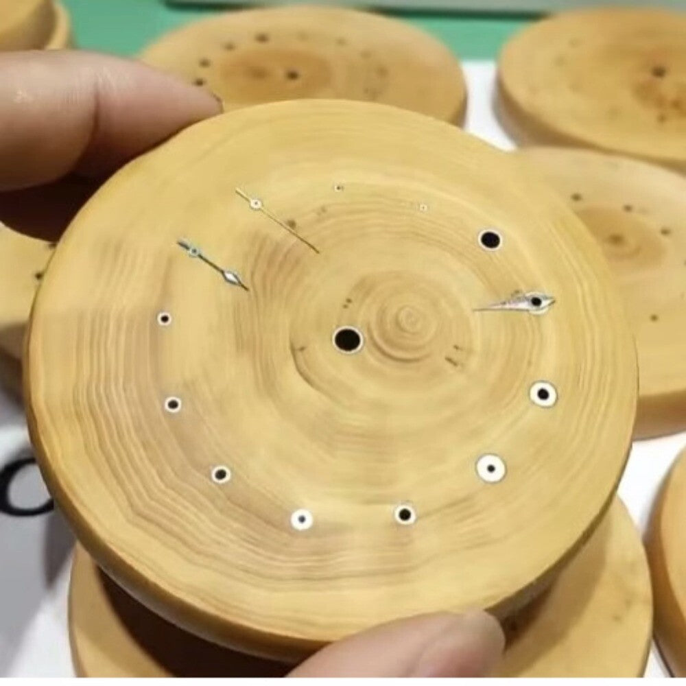 Boxwood watch hand wheel with copper tube mount holder for precise balance assembly.