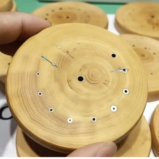 Boxwood watch hand wheel with copper tube mount holder for precise balance assembly.