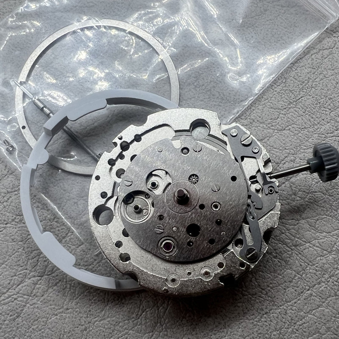 Miyota 8245 automatic movement watch with silver skeleton dial featuring 2 hands, elegant design.