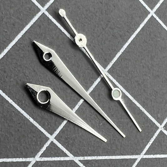 Silver 13mm arrow-shaped watch hands set by Trim, designed for Ronda 515 quartz movement timepieces.