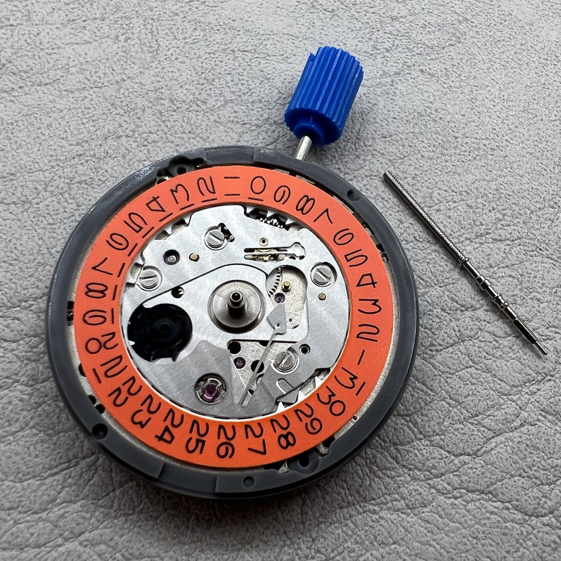 Seiko NH35 watch movement with vintage orange date wheel, 24 jewels for precise automatic timekeeping.