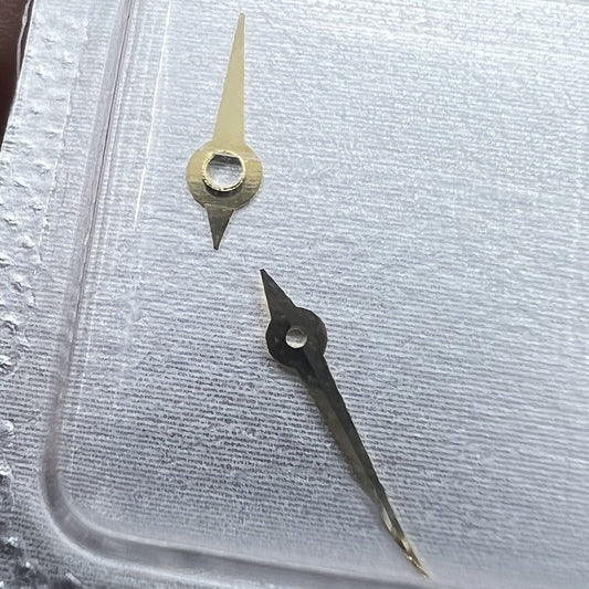 Golden watch hands set with hour, minute, and second hands for 976.001 movement.