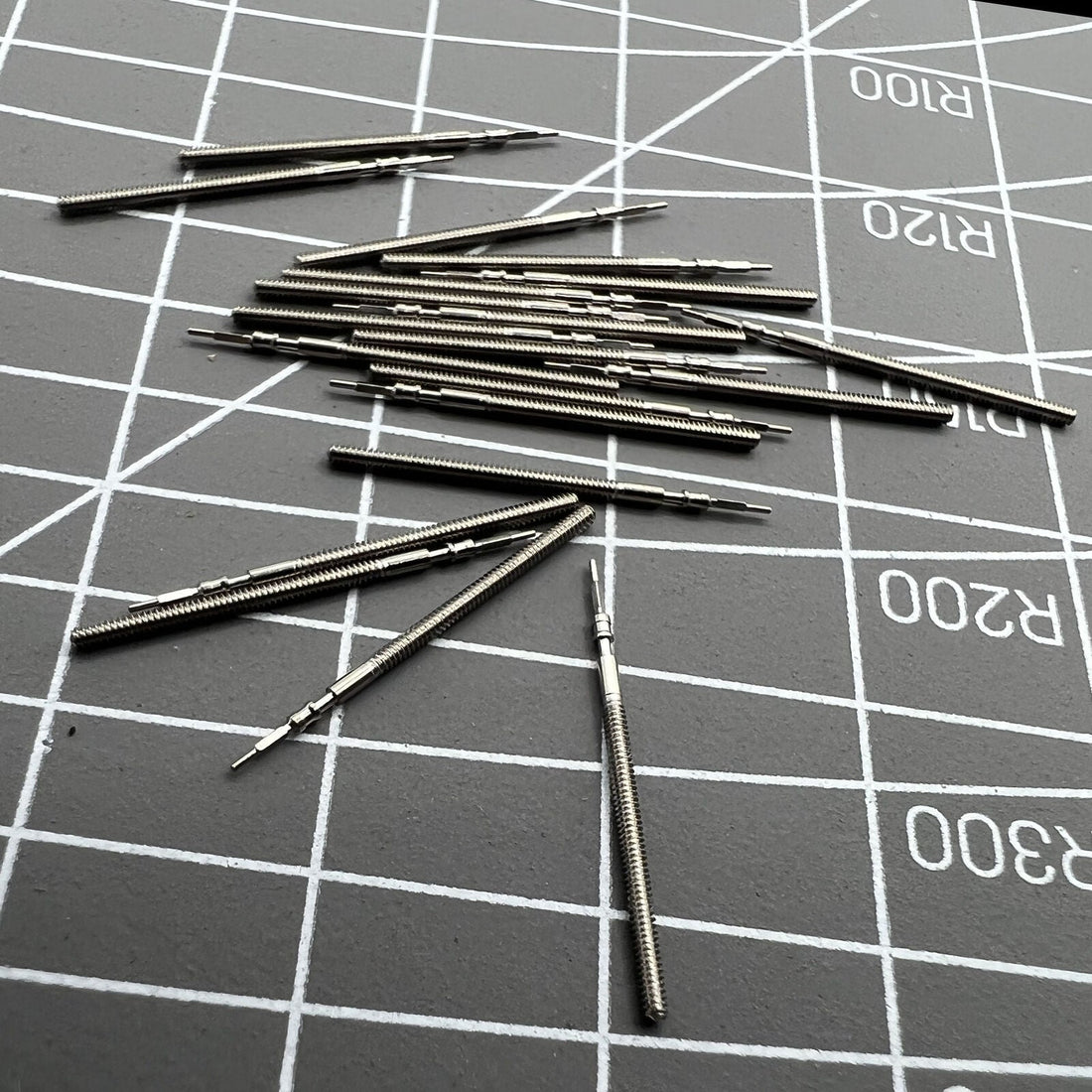 Set of 10 generic watch winding stems for 1M02, 1L22, 1M12, 1L02 movements, compatible with various watch repairs.
