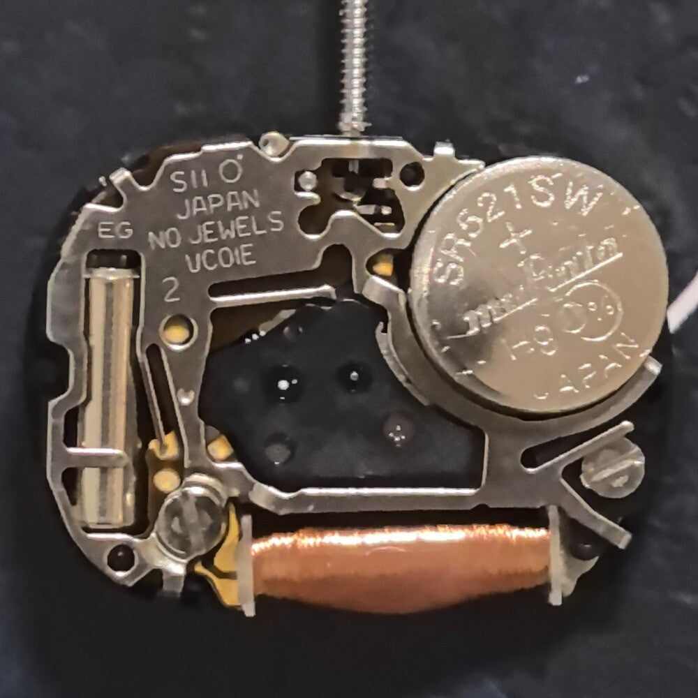 Hattori Japan VC01 quartz watch movement with 3 hands, precise replacement part for watch repair.