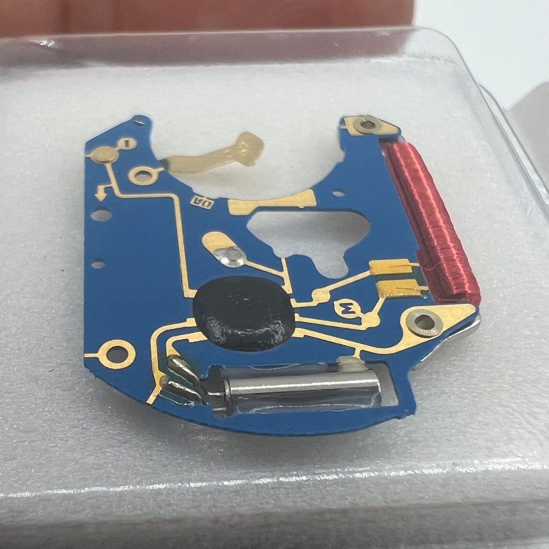 Close-up of brand-new ETA 955.112 circuit board for watch movement repair, high-quality replacement parts.
