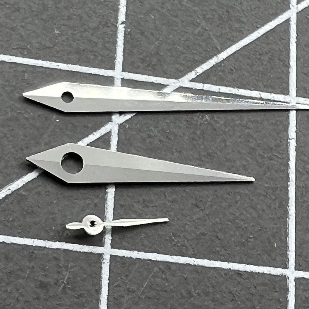 Polished silver arrow-shaped watch hands set for Miyota 1L45 quartz movement, durable & sleek design.