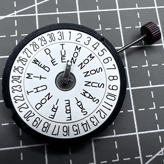 Swiss Ronda 517 quartz watch movement showing date window at 12 o'clock, precise timekeeping by Ronda.