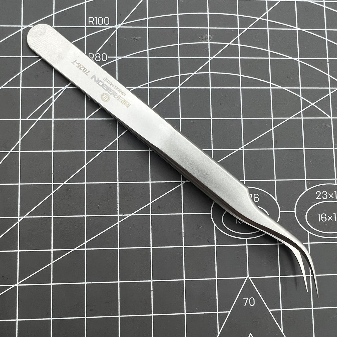 Swiss Bergeon 7026-7 antimagnetic tweezer with fine curved tips for precise watch repair tasks.