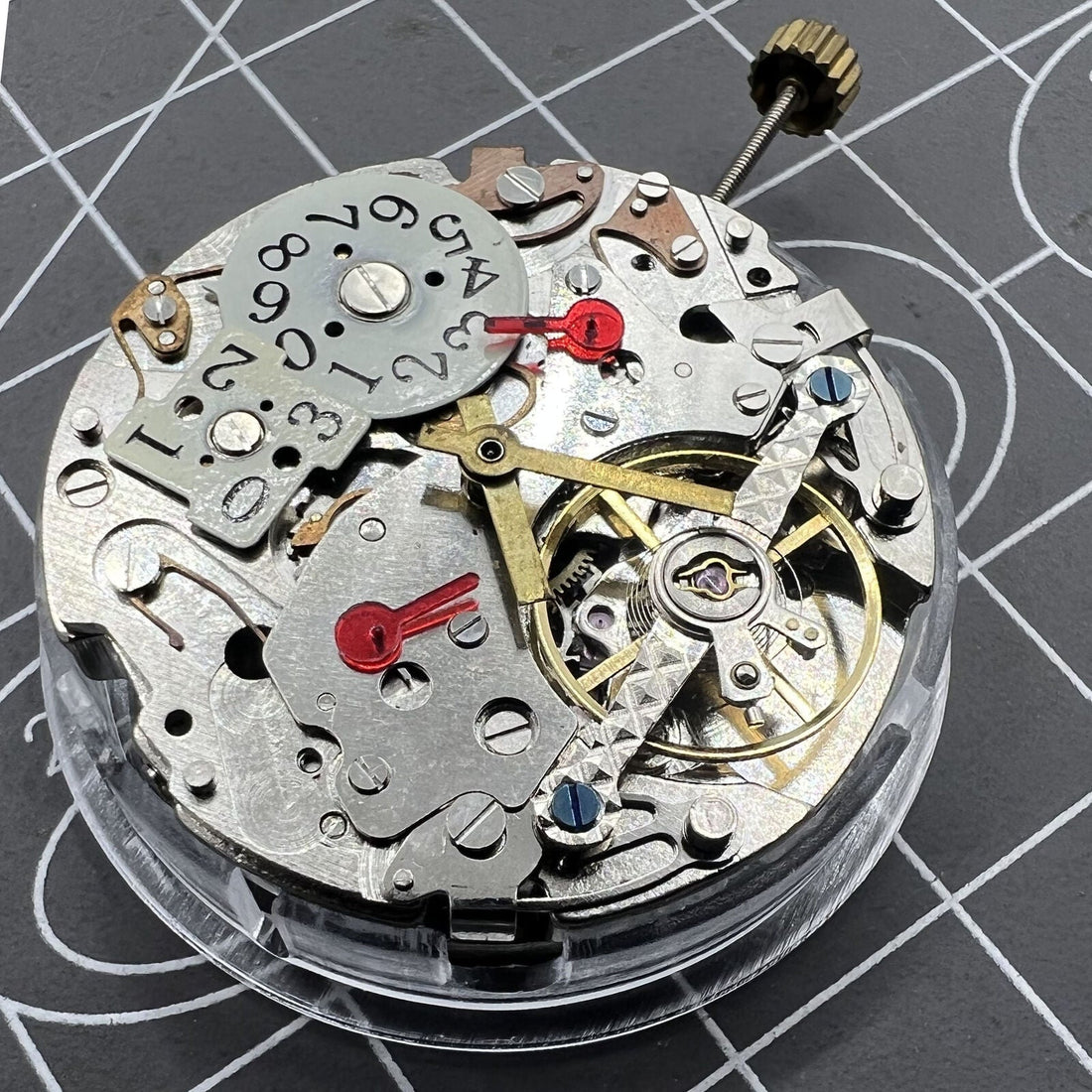 Automatic multifunctional watch with mechanical movement, date at 12 o?clock, bare wheel at 6, branded design.