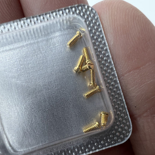 Golden 3x1mm slotted watch back cover screws for Cartier men's watches, durable and precise replacement parts.