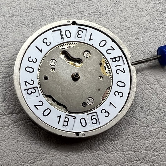 Swiss Ronda 5050B quartz movement watch mechanism with date at 6 o'clock and three hands, ideal for precise timekeeping.