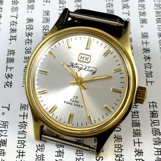33mm China Made manual mechanical watch with golden nail markers and silver dial, shock-resistant design.