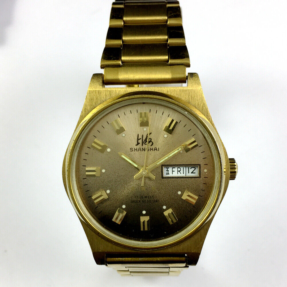 Shanghai brand manual mechanical watch with dark brown dial and double calendar function, elegant design.