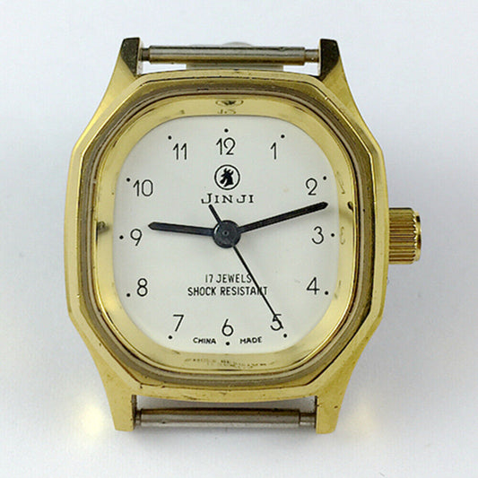 SHANGHAI JINJI lady watch with 17 jewels, golden case, and numeral nail markers, elegant mechanical design.