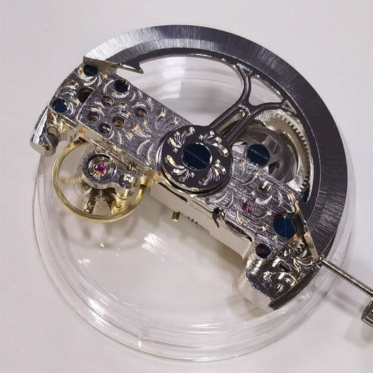 Rectangle auto chronograph watch movement showing balance wheel at 10 o'clock and rotor weight.