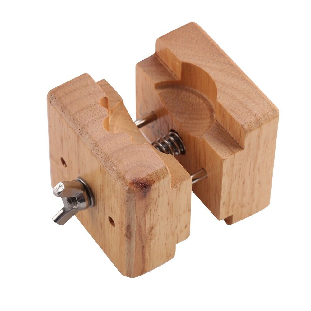 Professional wooden watch case holder block, secure vise clamp for precise watchmaker repairs.