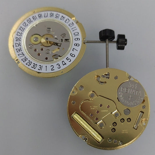 Ronda 1005 Slimtech Swiss quartz watch movement with gold plating and date display at 6 o'clock.