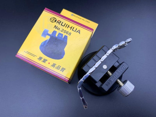 Watch band link remover tool with hammer and punch pins for precise bracelet repair.