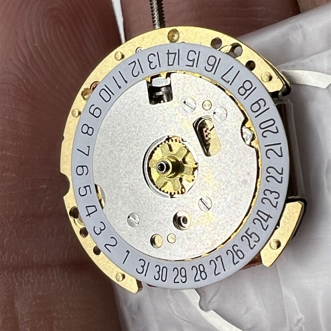 Ronda 775 Swiss Made golden quartz watch movement with date display at 6 o'clock