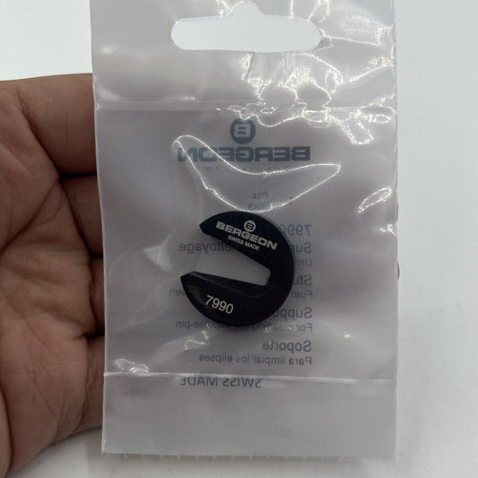 Bergeon 7990 watchmaker?s support tool holding balance wheel impulse-pin for precise cleaning.