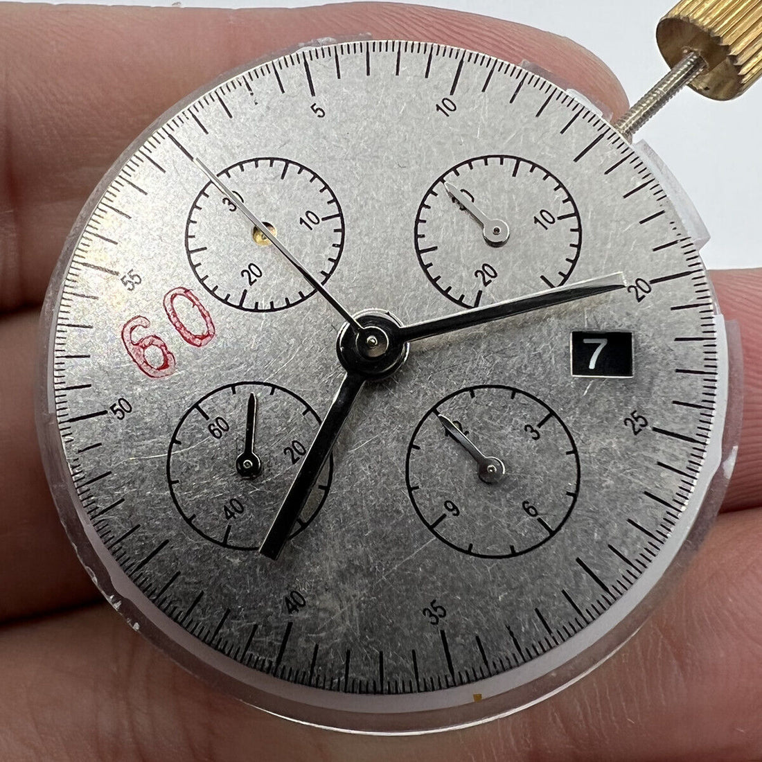 Black Dandong 7753 automatic watch with small second at 9, precision mechanical movement from China.