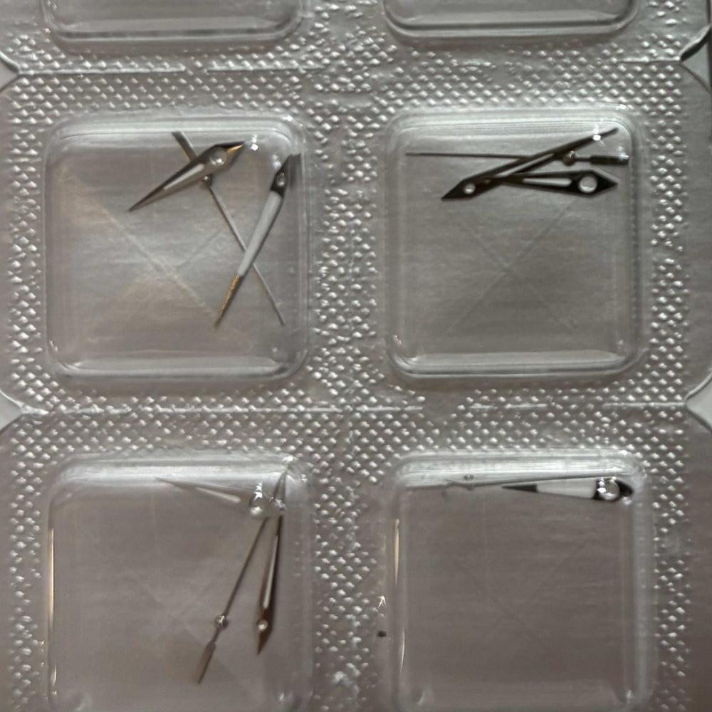 Silver watch hands for ETA255.111 and ETA255.112 movements, precision crafted accessory for watch repair.
