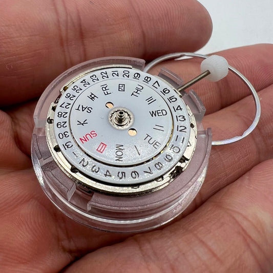 DG2813 automatic watch movement showing mechanical gears and day-date display for replacement parts.