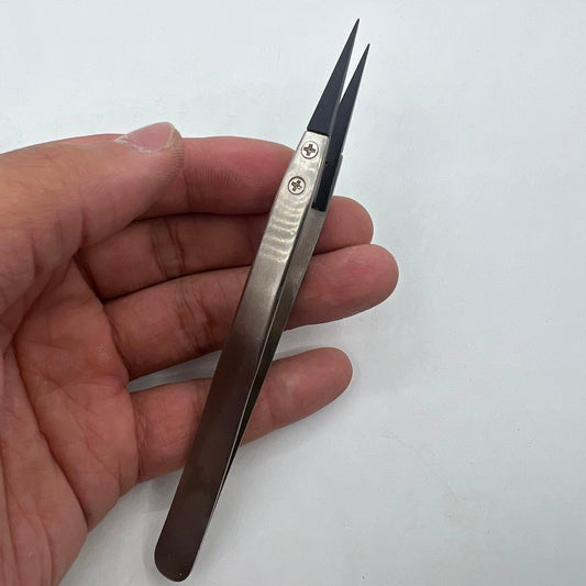 Stainless steel tweezers with carbon fiber tips for precision watch repair.
