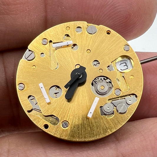 Golden ISA 9232 watch with quartz movement, date at 3 o'clock, and three hands for precise timekeeping.
