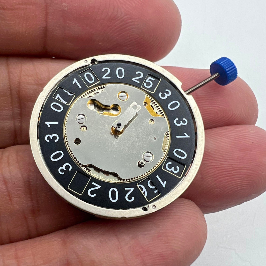 Ronda 4120B quartz watch movement with black disk wheel for precise timekeeping and durability.