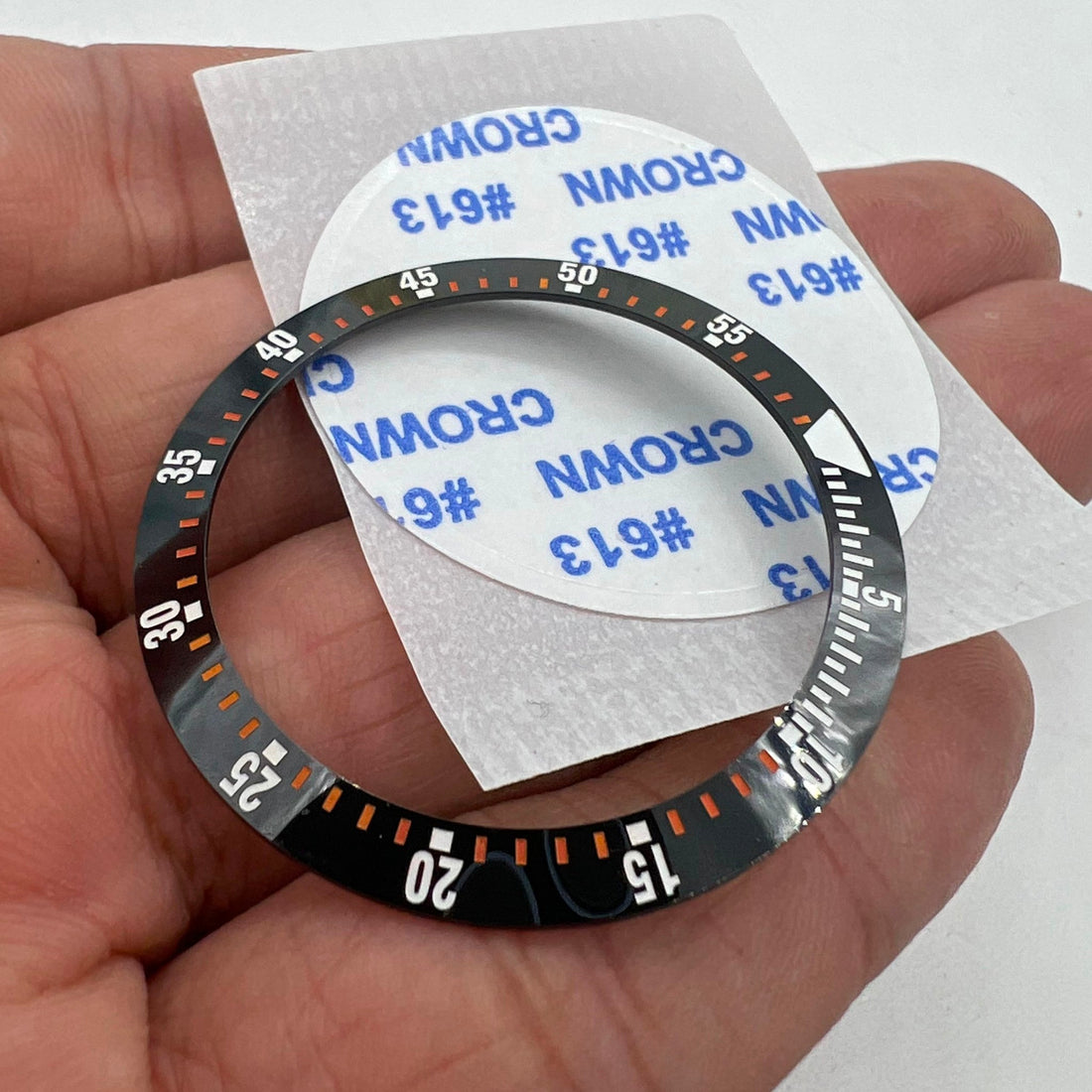 38mm black ceramic bezel insert with orange graduation for watch repair and customization.