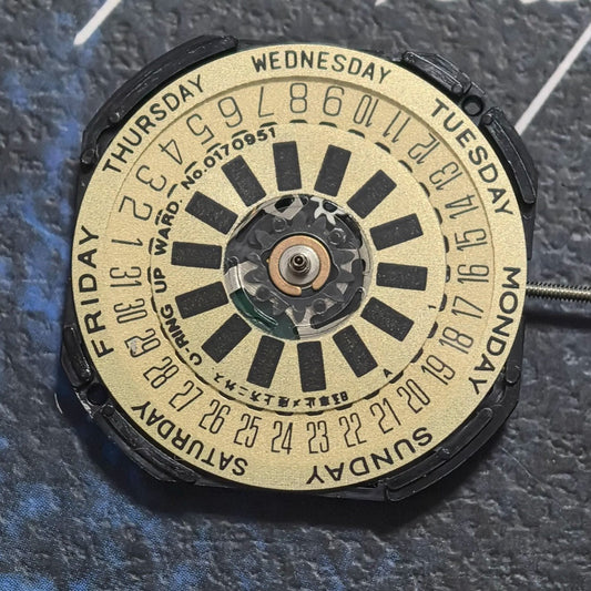 Close-up of Hattori VP44 Quartz watch movement with three hands and date display at 6 o'clock position, ideal for replacements.
