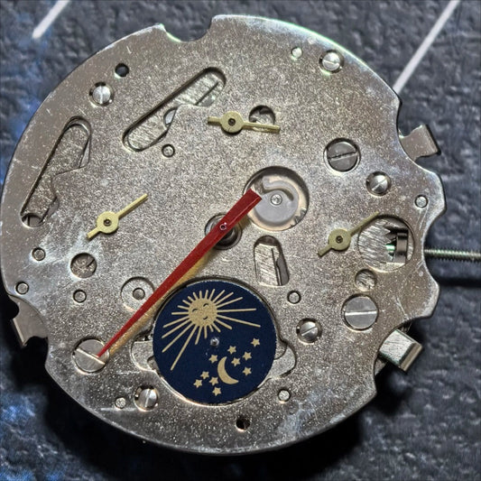 Silver mechanical watch part with small second subdial at 3, 9, and 12 o'clock, China made precision.