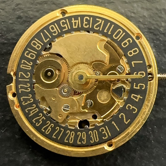 Swiss Made ETA256.041 quartz watch part with black disk date at 6, 2-hand movement for precise timekeeping.