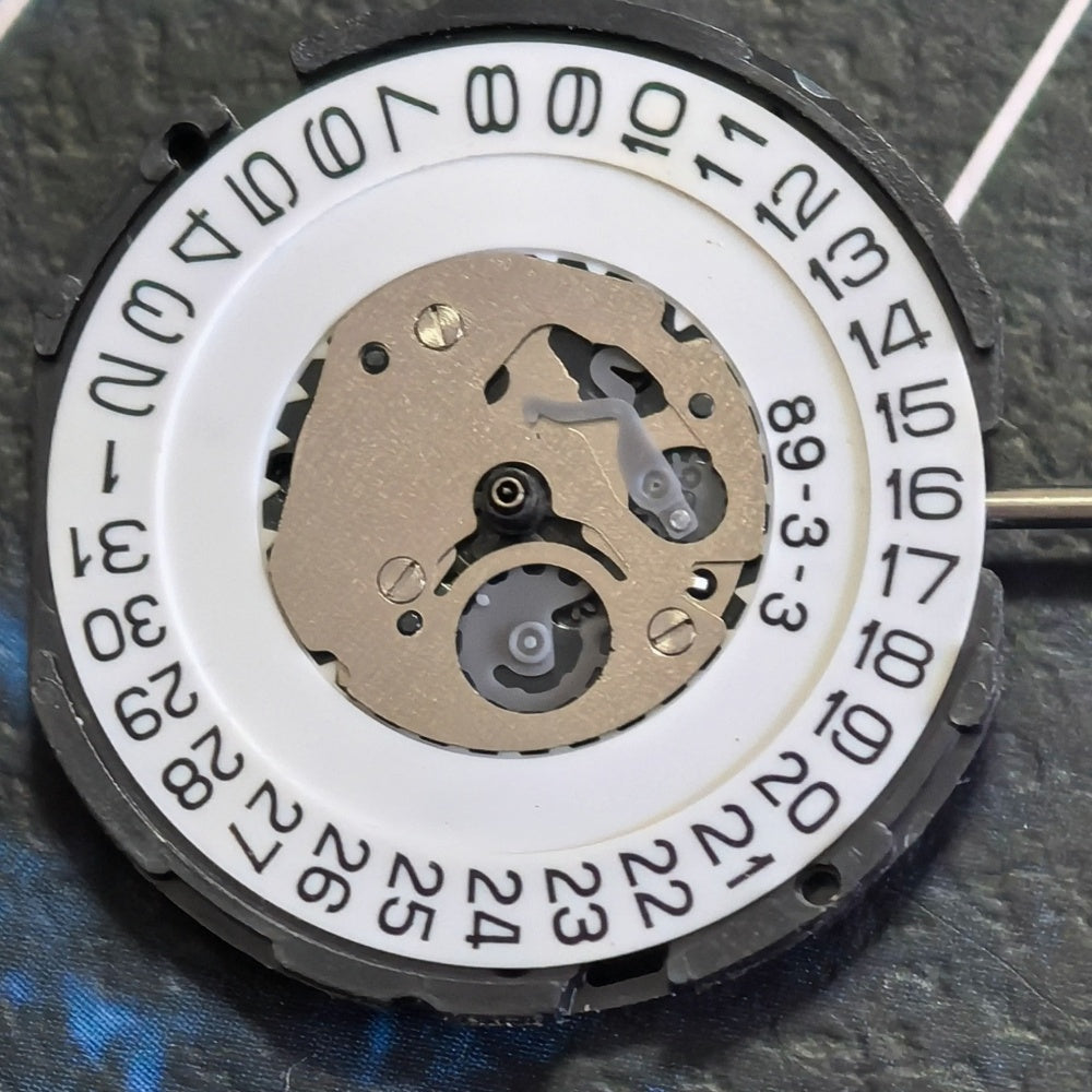 Japan Made 5F10B quartz movement watch repair part with 3 hands, precision timekeeping component.